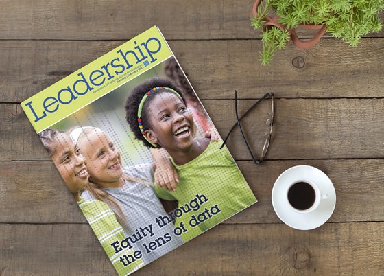 Leadership magazine on a table with eyeglasses and coffee.